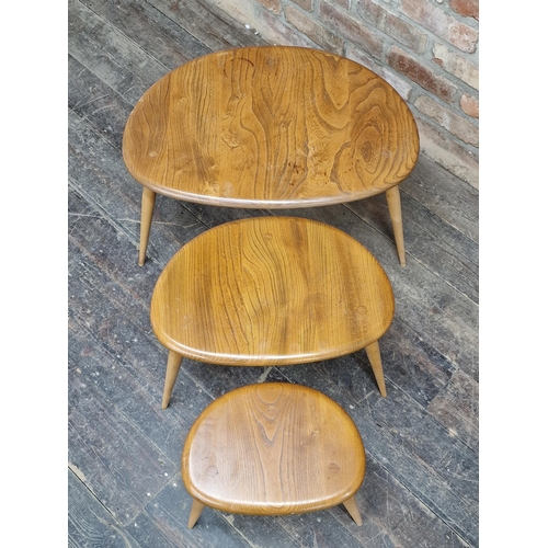 1164 - An Ercol light elm nest of three pebble tables, H 40cm x W 65cm (largest)