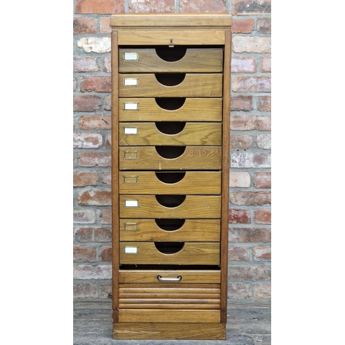 1254 - Vintage oak tambour fronted filing cabinet fitted with nine drawers, key, H 129cm x W 46cm x D 37cm