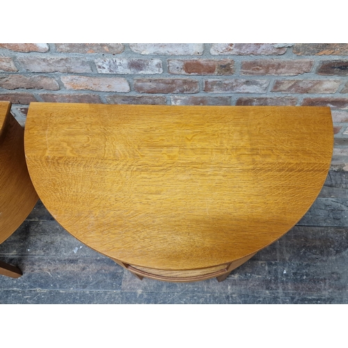 1177 - Pair of contemporary oak demi lume hall tables with central open cupboard, H 77cm x W 82cm x D 44cm ... 