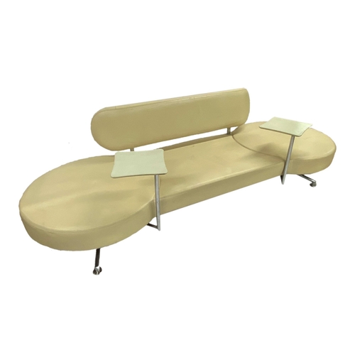 1363 - Probably by B&B Italia - Cream leather 'Dog Bone' sofa, fitted with two revolving wine tables upon a... 