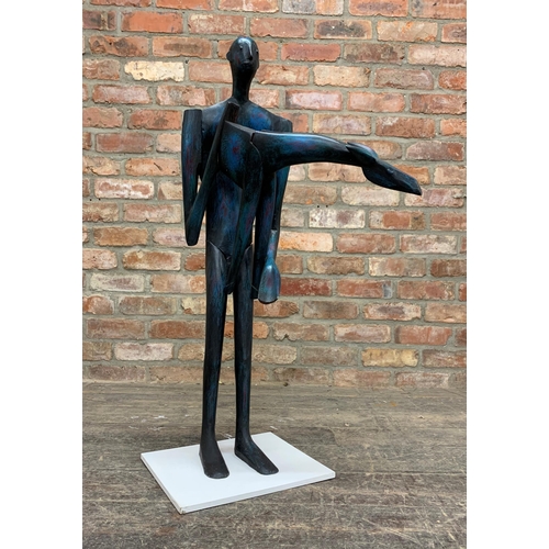 1380 - John Wragg (1937-2020) - Standing man holding a giraffe, painted wooded sculpture, 96cm high