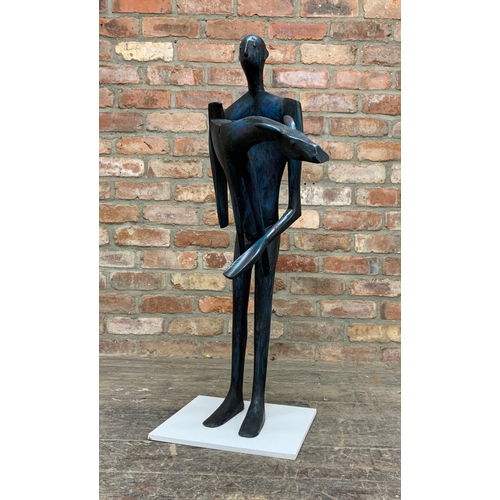 1380 - John Wragg (1937-2020) - Standing man holding a giraffe, painted wooded sculpture, 96cm high