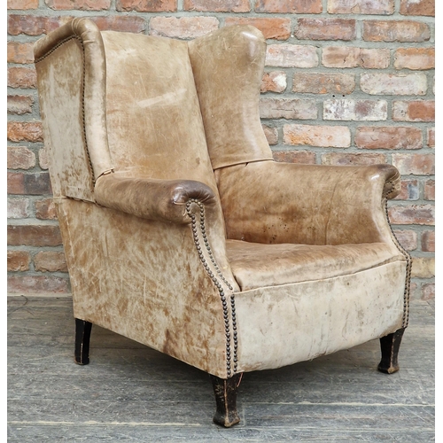 1283 - Vintage studded leather wingback armchair, H 96cm