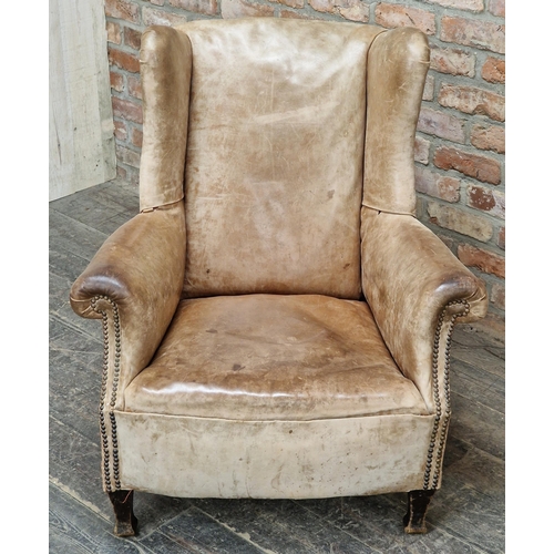 1283 - Vintage studded leather wingback armchair, H 96cm