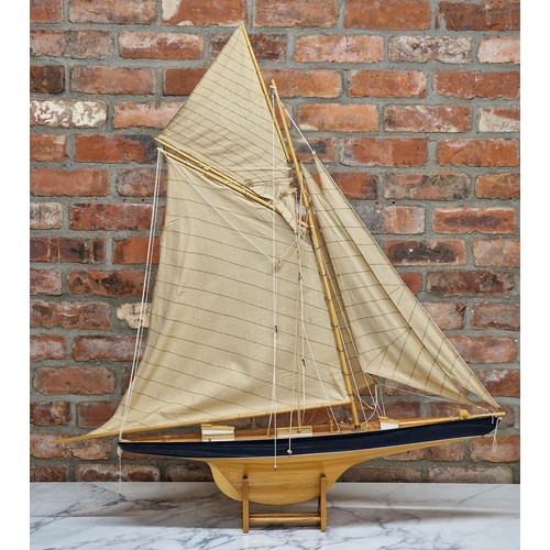 1588 - Large handmade wooden yacht on stand, having hand painted blue hull and cloth sails, L 120cm x H 120... 