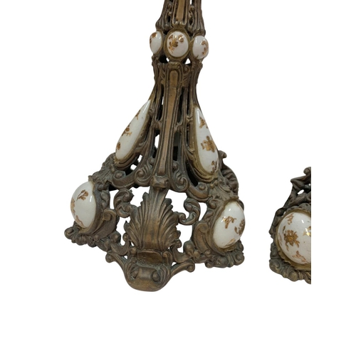 1110 - Pair of 19th century bronze candlesticks, having pierced stem and scallop shell base with hand paint... 