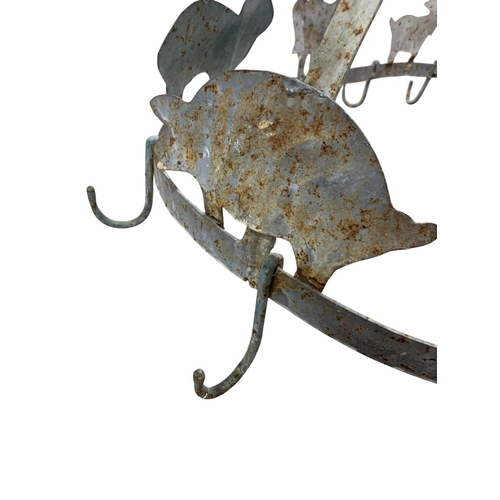 456 - Antique wrought iron twelve hook oval shaped game hanger, having raised farmyard animal decoration t... 