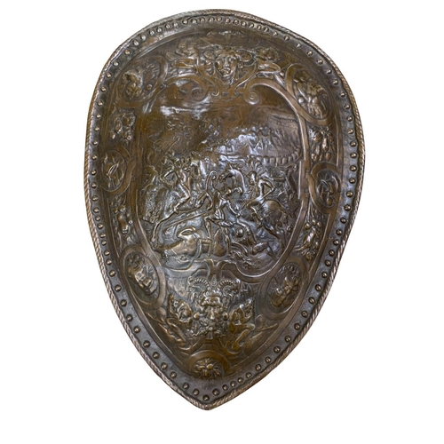 457 - Pair of bronze fronted composite wall shields, each having a decorative battle scene relief and stud... 