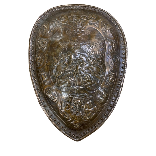 457 - Pair of bronze fronted composite wall shields, each having a decorative battle scene relief and stud... 