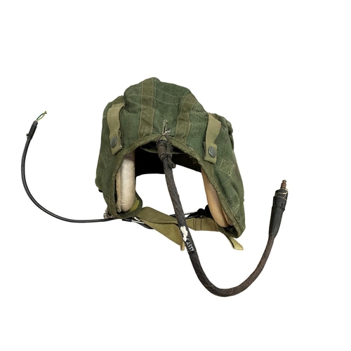 226 - British post war green canvas RAF size 1 flying helmet, together with a WW2 artillery shell