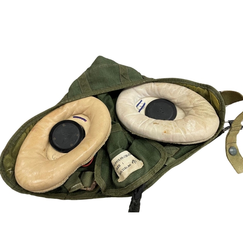 226 - British post war green canvas RAF size 1 flying helmet, together with a WW2 artillery shell