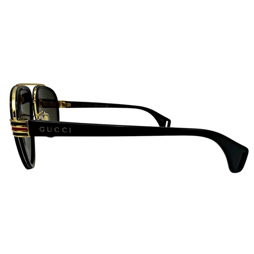 167 - A pair of Gucci Sunglasses for men with black and gold frame and brown lenses. Model number GG0447S.... 