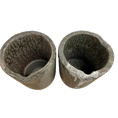 1003 - Pair of foundry lava stone smelting pots, having original traces of smelted brass, H 40cm