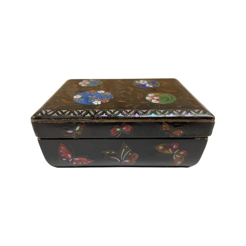 265 - 19th century black lacquered box with butterfly wing circular panels fronted by enamel floral detail... 