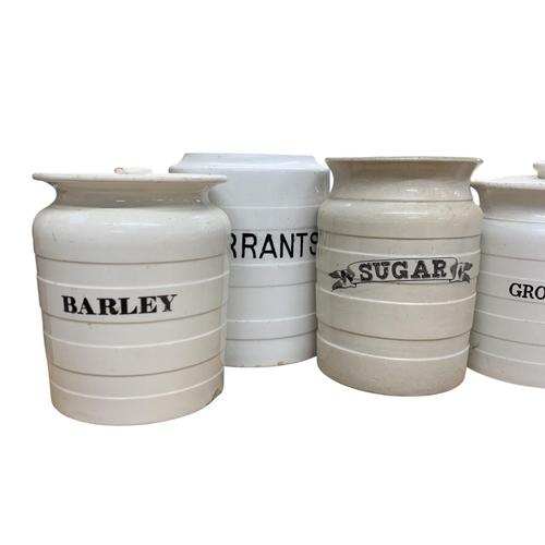 330 - Collection of white banded ceramic kitchen cannisters to include Tapioca. Ground Rice, Currants, Sug... 