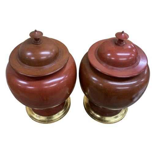 347 - Pair of very large Chinese sang de boeuf ceramic lidded urns on gilt wood stands, H 65cm