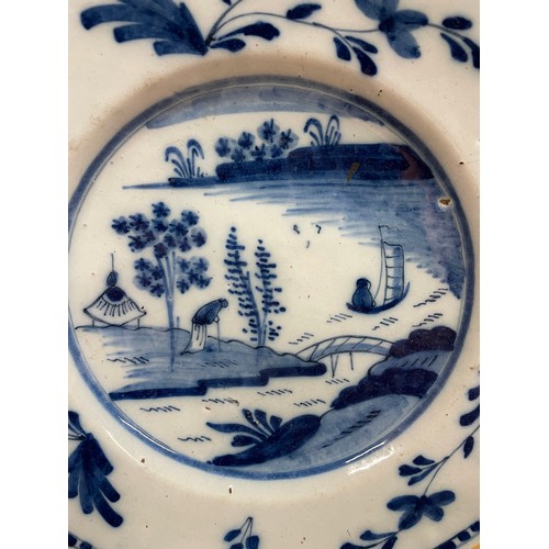 355 - 18th Century Bristol delft blue and white plate, the central scene with elder and small boat, border... 