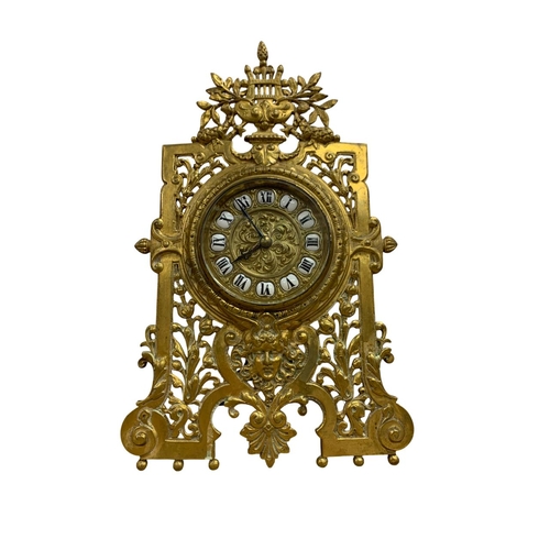 204 - Pierced brass easel back desk clock with harp and mask details, the dial with black Roman numerals o... 