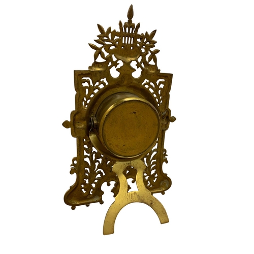 204 - Pierced brass easel back desk clock with harp and mask details, the dial with black Roman numerals o... 