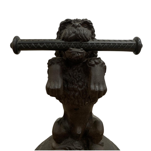 485 - French antique cast iron begging dog door stop, holding a scroll in its mouth and mounted atop a cas... 