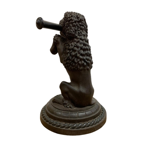 485 - French antique cast iron begging dog door stop, holding a scroll in its mouth and mounted atop a cas... 