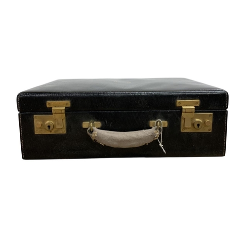 564 - Antique leather and brass clasped vanity case, having initialled 'N.W' to front with fitted leather ... 