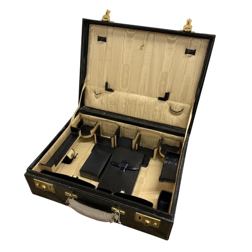 564 - Antique leather and brass clasped vanity case, having initialled 'N.W' to front with fitted leather ... 