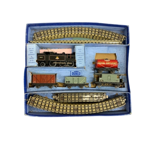 513 - Quantity of vintage boxed Hornby Dublo trains to include  L.M.S 6917 with carriages and tracks and a... 