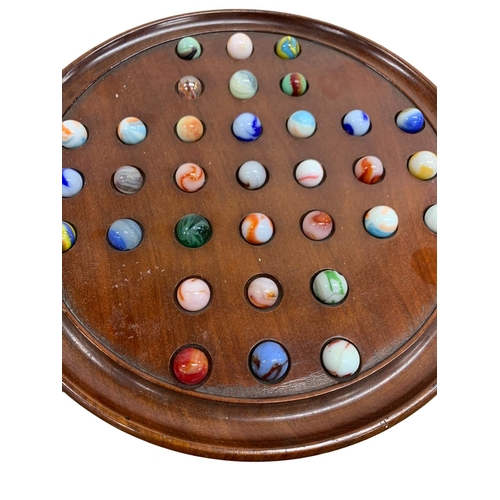 181 - Vintage wooden Solitaire game with assortment of multi coloured marbles