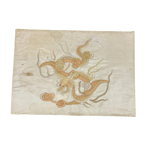 1536 - Pair of Chinese embroidered rectangular silk panels depicting dragons, on cream ground, 55cm x 38cm,... 