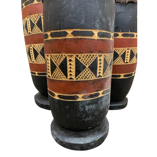 296 - Three African tribal hand carved wood and animal hide topped graduating drums, largest H 45cm