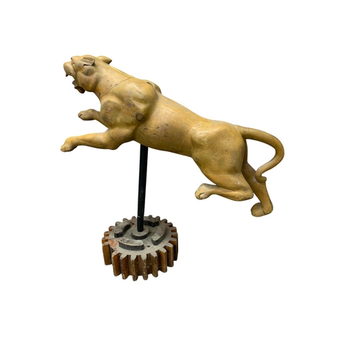 435 - Impressive hand carved wooden leaping panther figure, held atop unusual machine cog base, L 110cm x ... 