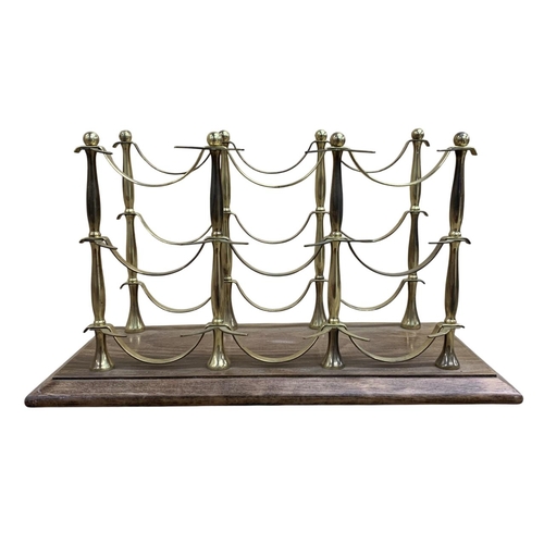 500 - Good quality brass wine bottle holder held atop wooden plinth base, 50cm x 24cm x 29cm