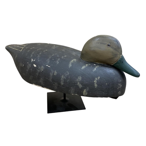 437 - Hand carved American Folk Art wooden decoy duck, held atop metal base, H 25cm x L 47cm