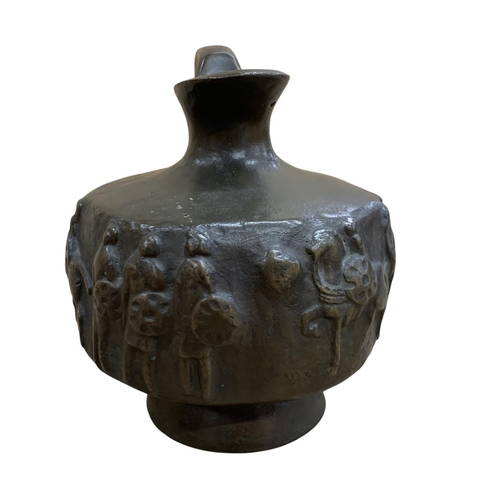 502 - Heavy bronze archaic style ewer jug, having battlescene relief throughout, H 19cm