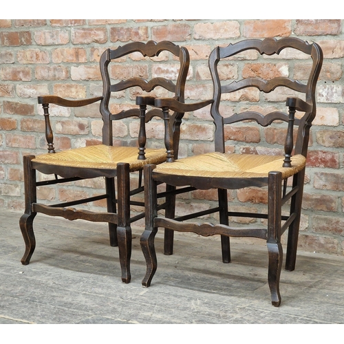 1259 - Pair of antique oak ladderback armchairs with rush seats, H 90cm (2)