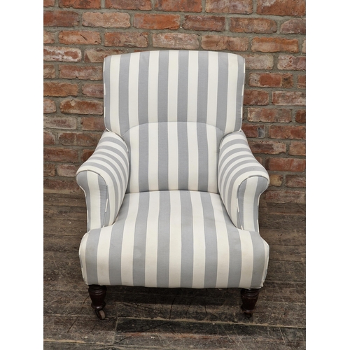 1293 - Antique Howard style armchair with striped upholstery and ceramic castors, H 86cm x W 75cm x D 75cm