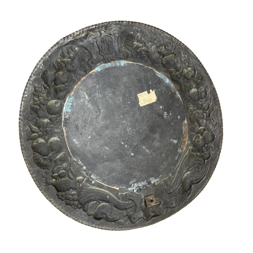 1186 - Circular copper border bevelled wall mirror, having intricate cornucopia, fruit and crested border, ... 