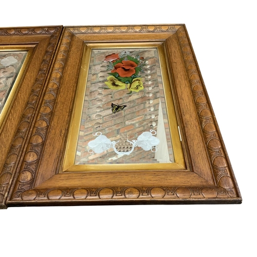 1185 - Pair of hand painted floral and butterfly Gypsy mirrors, held in carved oak frames, 82cm x 52cm