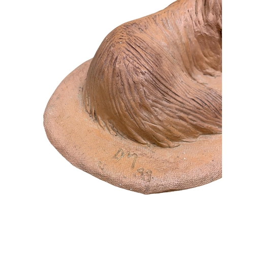 1472 - Deborah McCabe (20th/21st century) sitting Afghan Hound, clay sculpture, signed and dated, L 34cm x ... 