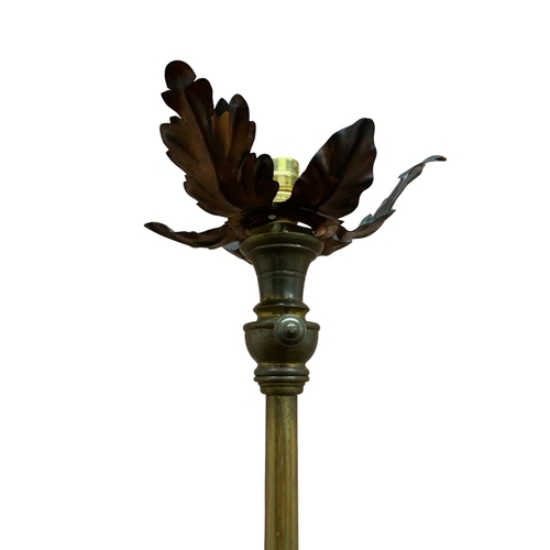 1170 - Antique brass twisted stem standard lamp, having applied acanthus leaf detail with three footed pawb... 