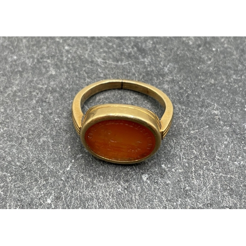 51 - Antique unmarked high carat gold carnelian seal ring, carved with a cherub walking dogs in a landsca... 