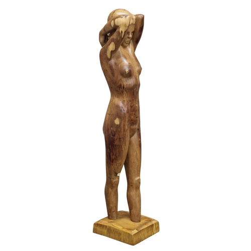 1476 - Carved yew wood sculpture of a nude woman raised on a chamfered square cut base, H 142cm