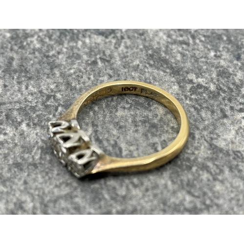 95 - Mid 20th century gold and diamond three stone illusion ring. The graduated eight-cut stones all grai... 