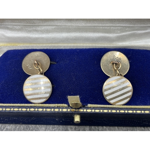 98 - Pair of early 20th century gold and white enamel round twin-panel cufflinks. With chain inter-links,... 