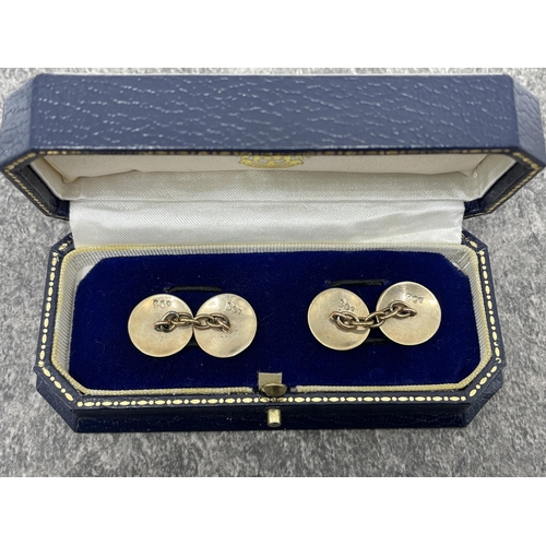 98 - Pair of early 20th century gold and white enamel round twin-panel cufflinks. With chain inter-links,... 