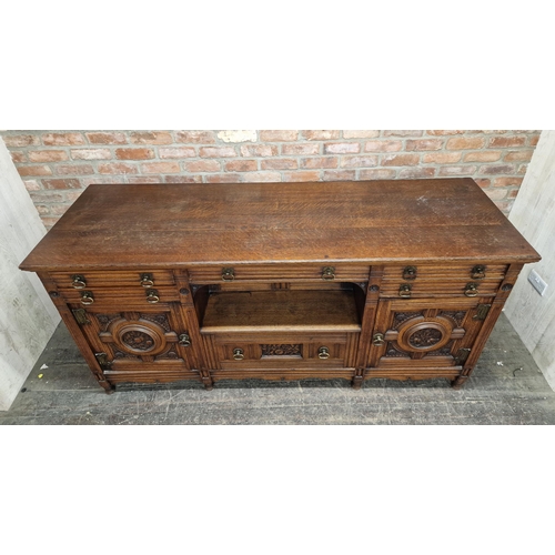 1362 - Antique oak sideboard with carved floral detail, fitted with an arrangement of drawers and cupboards... 