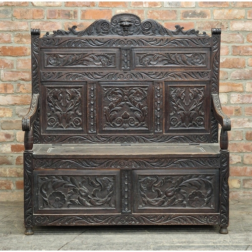 1377 - Victorian carved oak settle with rising hinged lid, H 38cm x W 123cm x D 58cm