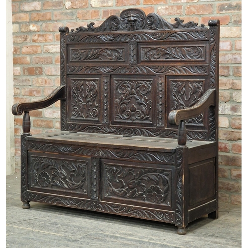 1377 - Victorian carved oak settle with rising hinged lid, H 38cm x W 123cm x D 58cm