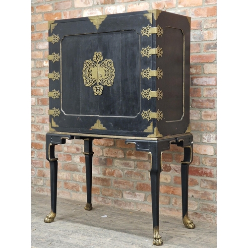 1384 - 20th century Chinese ebonised cabinet on stand with gilt metal mounts and mirrored shelved interior,... 